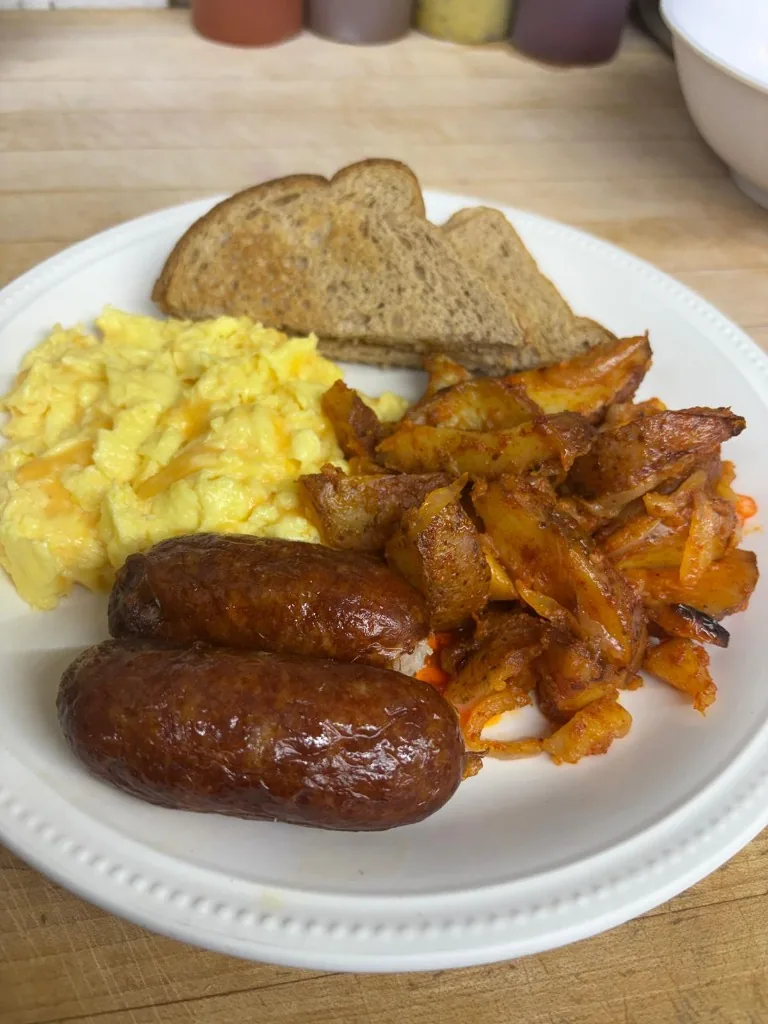 Farmer's Plate with scrambled eggs, melted cheddar cheese, breakfast sausage, seasoned home fries, and toast at Estime's Cafe Colonia NJ