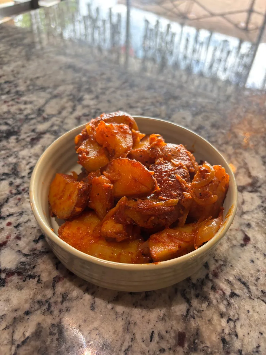 Bowl of seasoned crispy breakfast home fries side at Estime's Cafe Colonia NJ